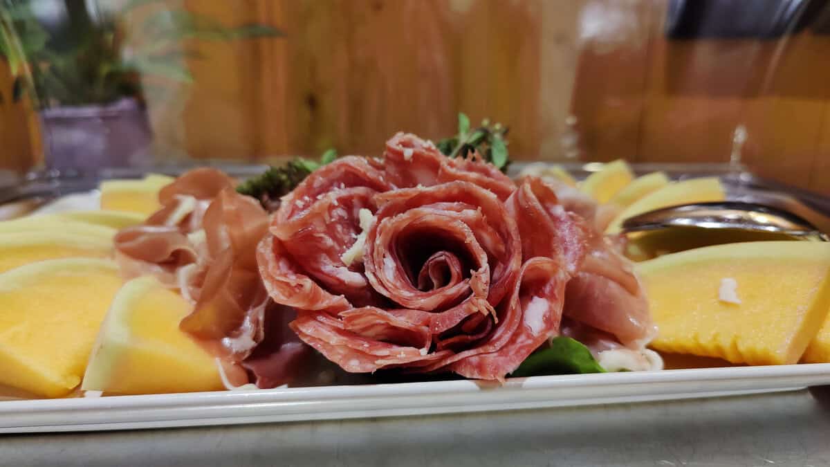 Arrange salami and cheese on the breakfast buffet
